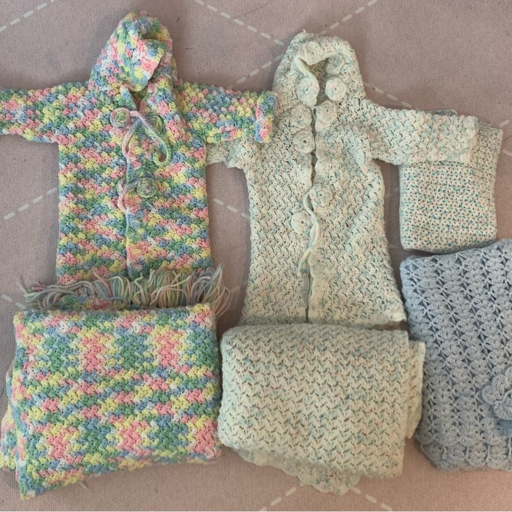 Homemade knitted baby coats and blankets